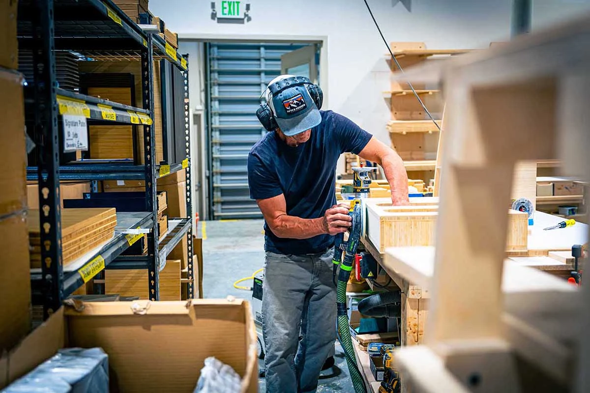 Geotrek van builder hand-finishing custom van cabinetry