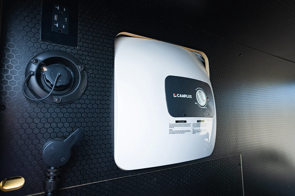 Camplux water heater mounted in the rear garage of a Geotrek Verus