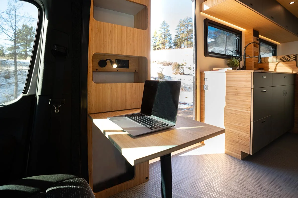Swiveled passenger seat facing a Lagun table with a laptop in a Geotrek Verus