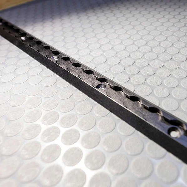 L-track installed in the floor of a Geotrek Verus