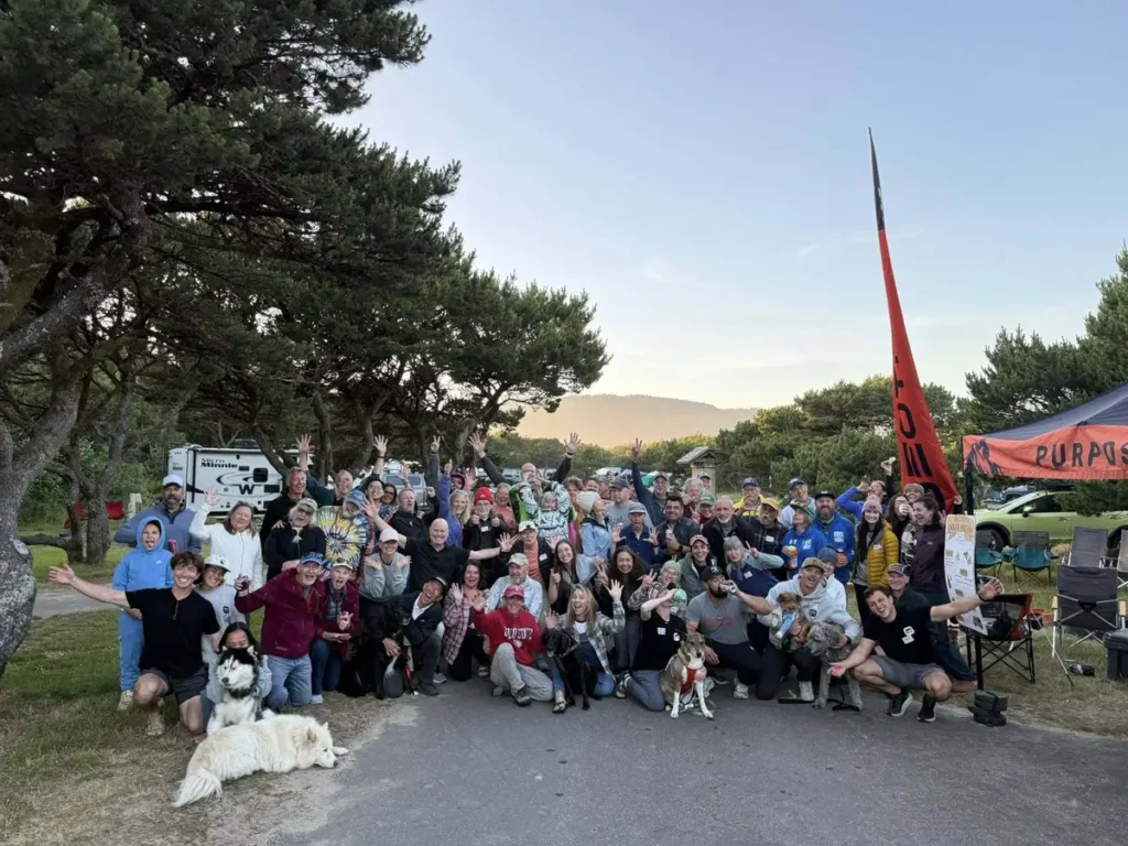 Group photo of Geotrek van owners and dogs at Oregon meetup campsite